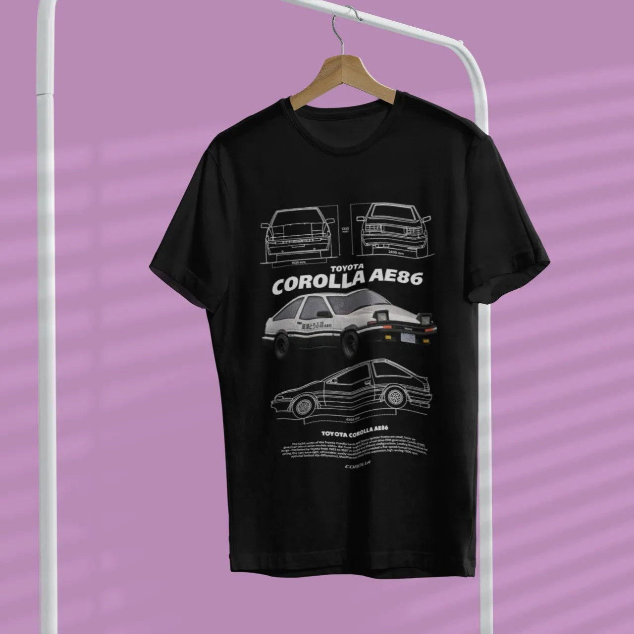 Black t-shirt with car graphics on a hanger against a purple background