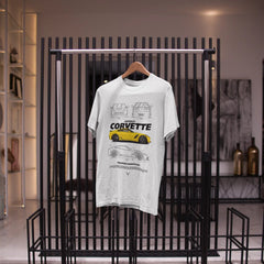 White t-shirt with Corvette design on a black rack in a store setting