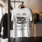 White t-shirt with black graphic design on a hanger in a store setting
