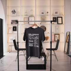 Black t-shirt with 'DELOREAN' design on a stand in a modern interior setting.