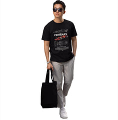 Person wearing a black Ferrari t-shirt holding a black bag on a white background