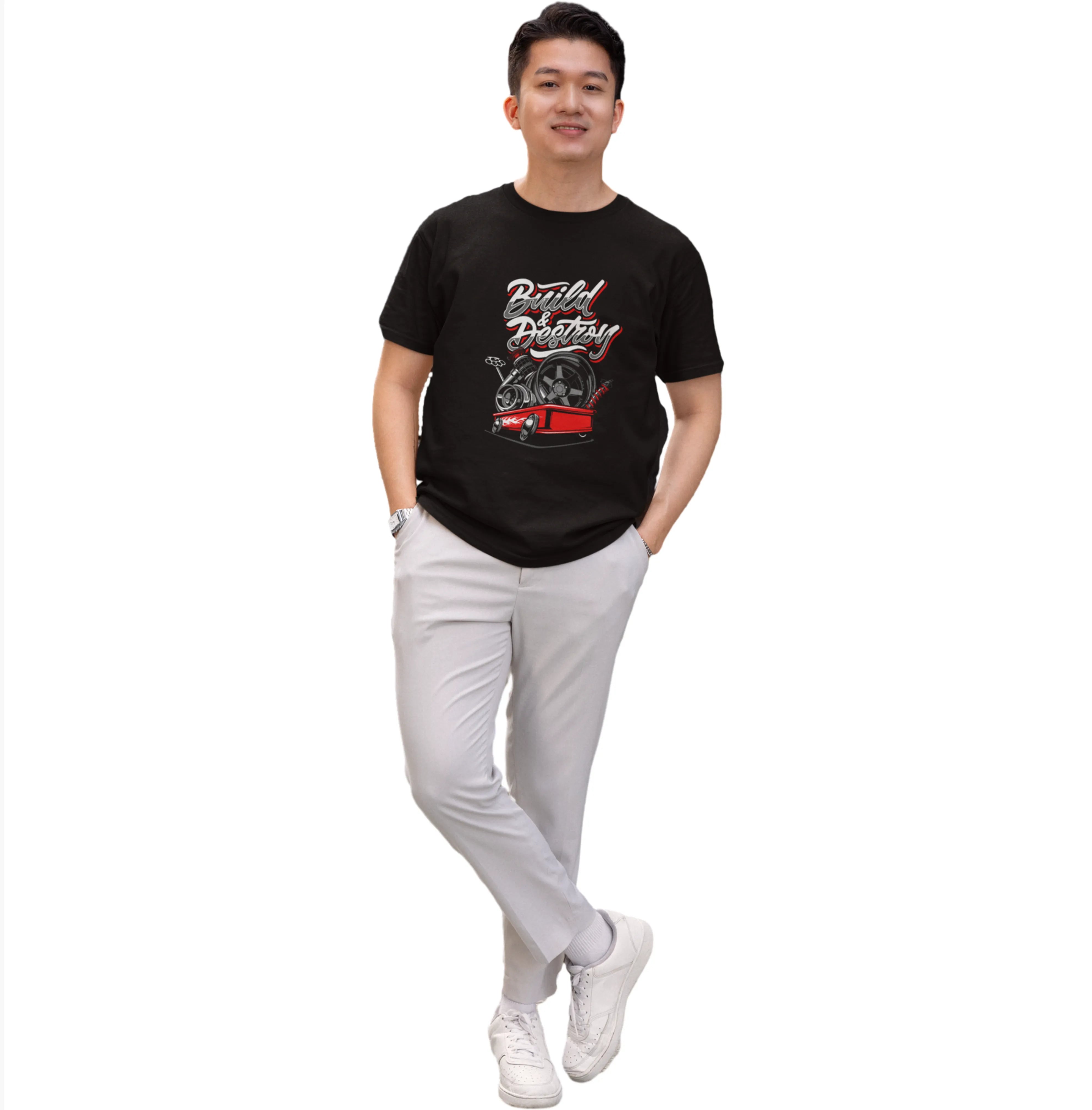 Person wearing a black t-shirt with graphic design and light gray pants on a white background