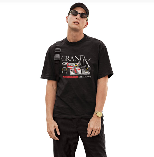 Man wearing a black t-shirt with 'Grand Prix' graphic design on a white background