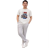 Person wearing a white t-shirt with graphic design on a plain background