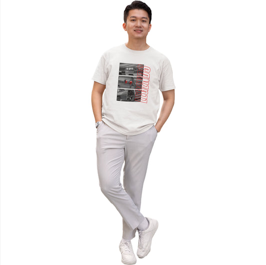 Person wearing a white t-shirt with graphic design and light gray pants on a white background
