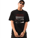 Person wearing a black t-shirt with a graphic design on a white background