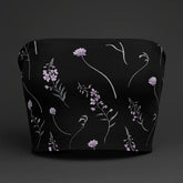Black top with floral pattern on a dark background