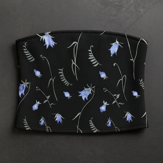 Black pouch with blue floral pattern on a dark gray background