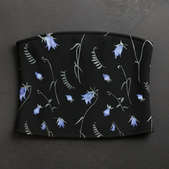 Black pouch with blue floral pattern on a dark gray background