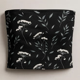 Black tube top with white floral pattern on a light gray background