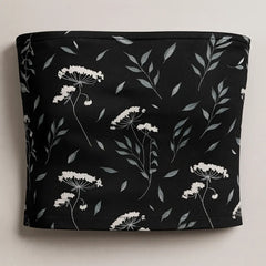 Black tube top with white floral pattern on a light gray background