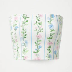Cylindrical container with floral pattern on a white background