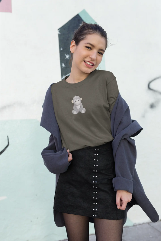 Woman wearing a green sweater with a teddy bear design and a black skirt against a graffiti-covered wall.