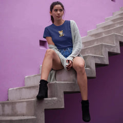 Woman sitting on a staircase against a purple wall
