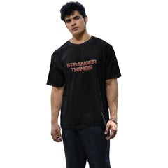 Person wearing a black 'Stranger Things' t-shirt on a white background