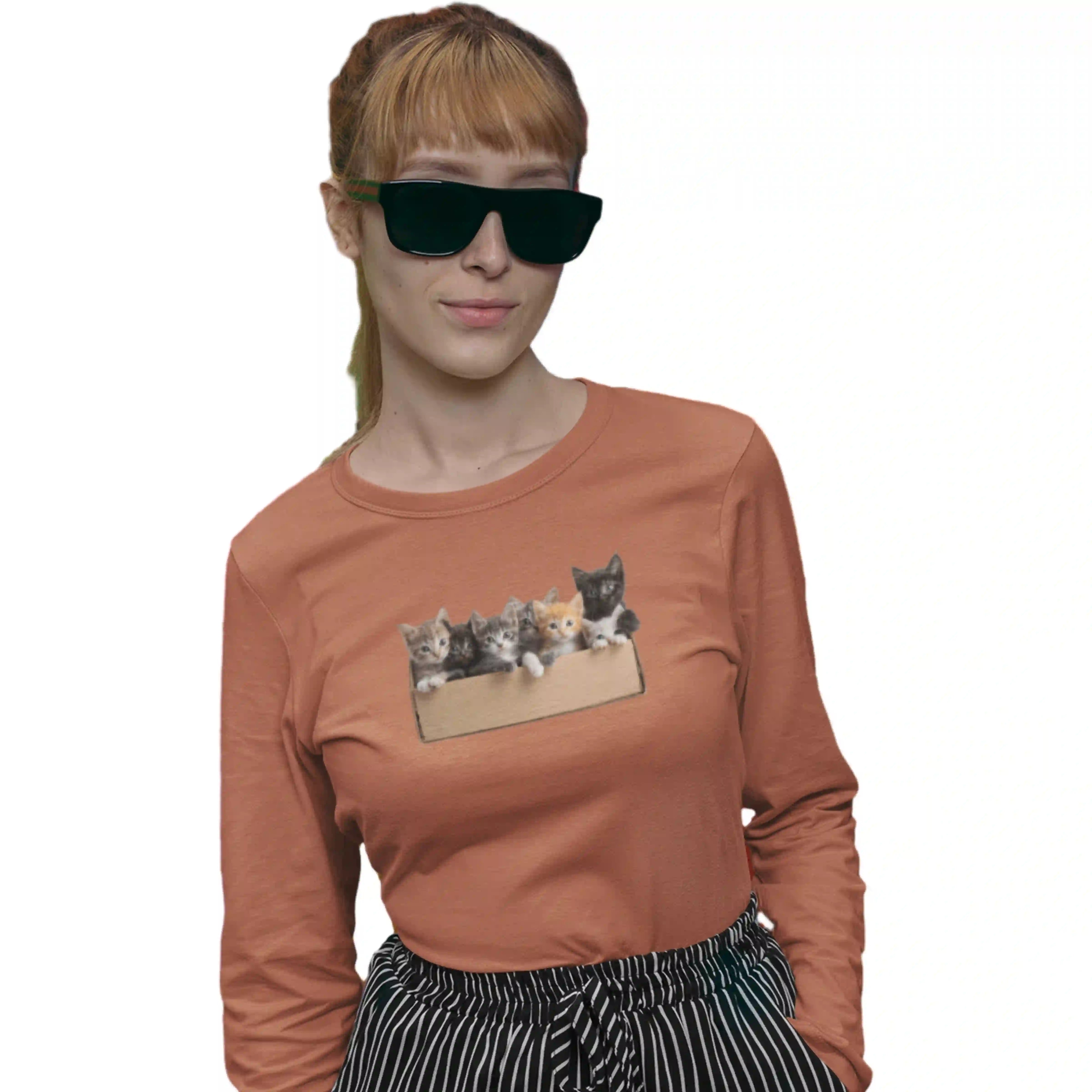 Person wearing a brown long-sleeve shirt with a cat graphic on a white background