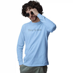 Man wearing a light blue long-sleeve shirt with 'You & Me' text on a white background