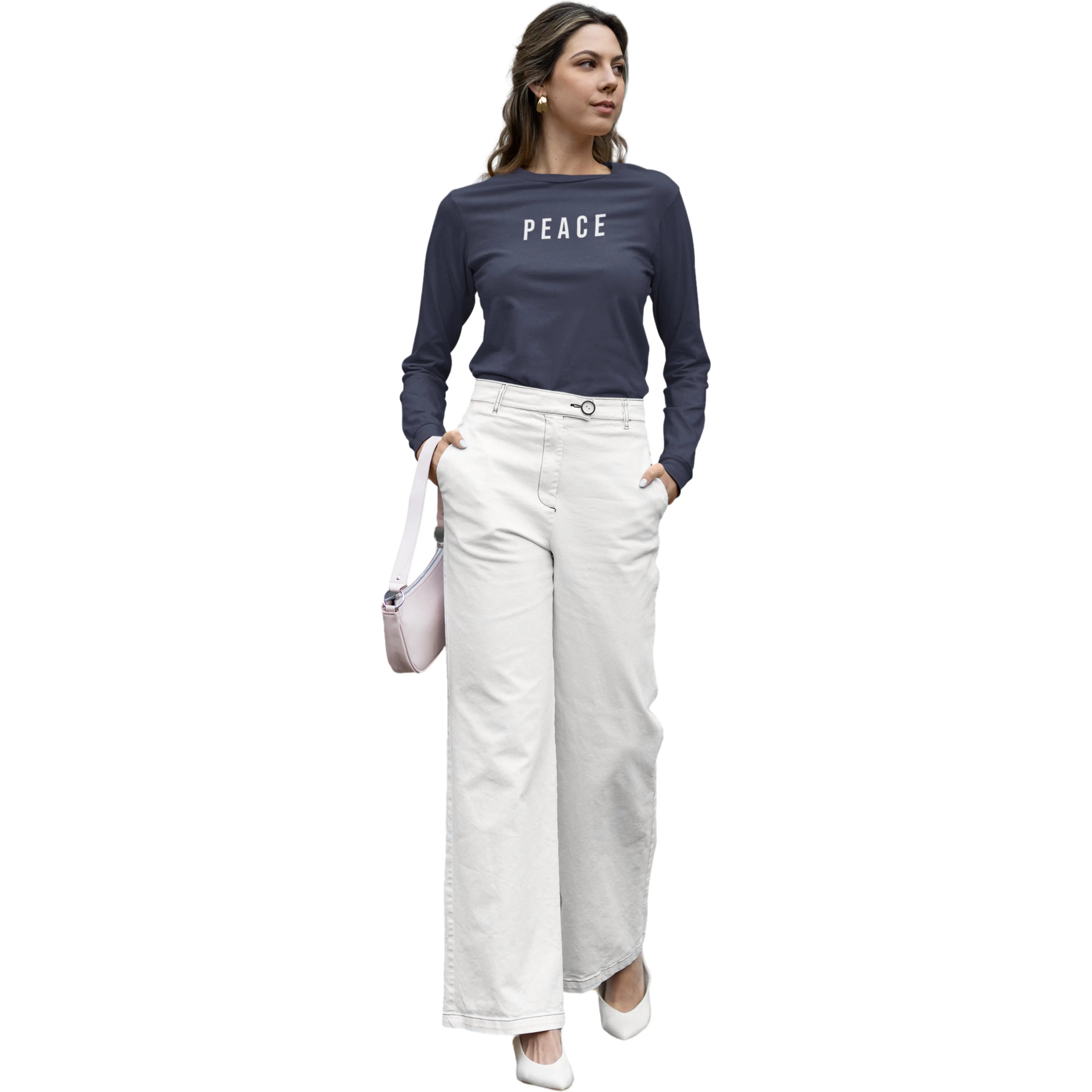 Woman wearing a navy blue 'PEACE' shirt and white pants on a white background