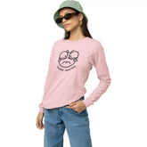 Person wearing a pink long-sleeve shirt with a graphic design on a white background