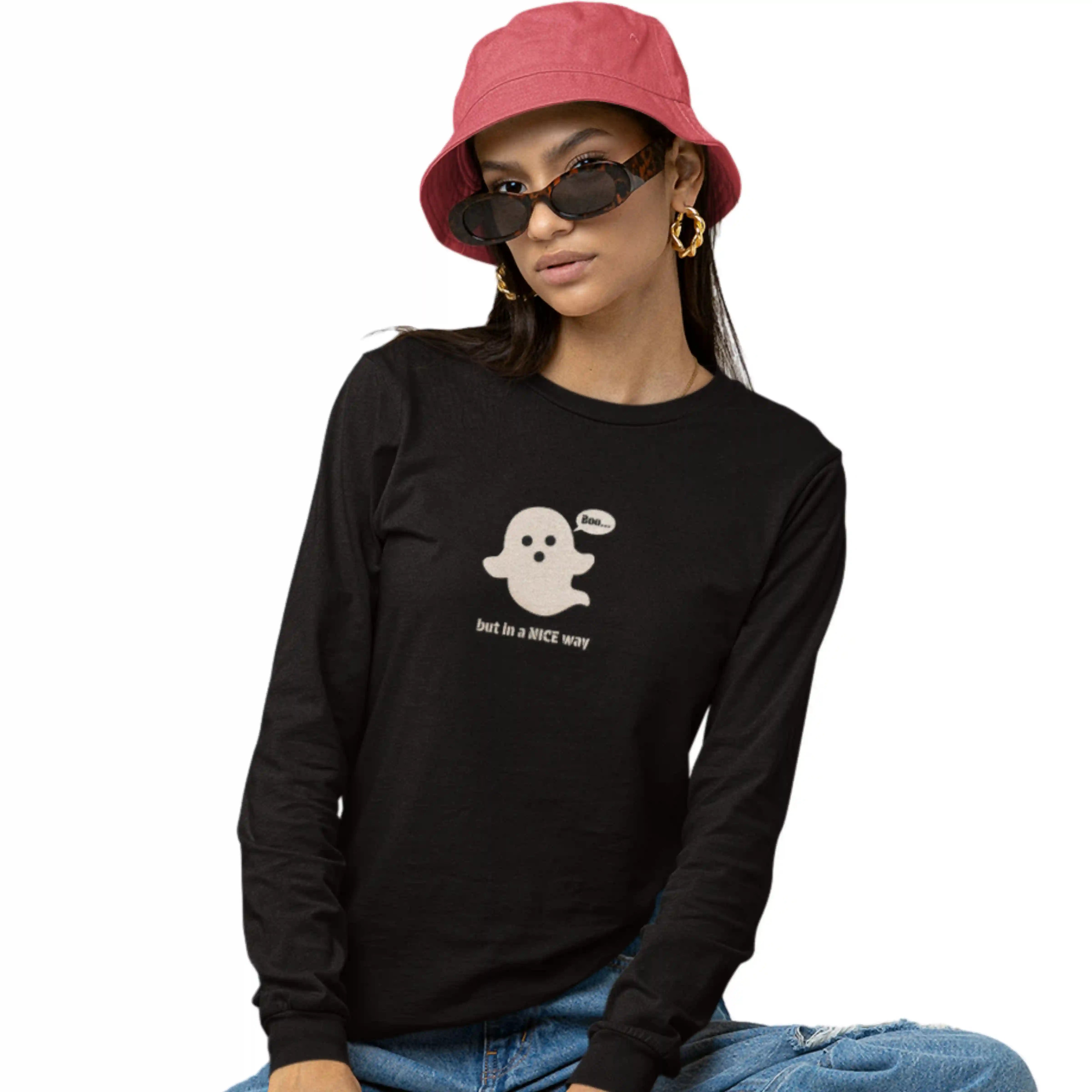 Person wearing a black long-sleeve shirt with a ghost graphic and text, paired with a red bucket hat and sunglasses on a white background.