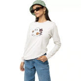 Person wearing a white long-sleeve shirt with a ghost graphic, blue jeans, and a green bucket hat on a white background.