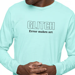 Person wearing a light blue long-sleeve shirt with 'GLITCH Error makes art' text.