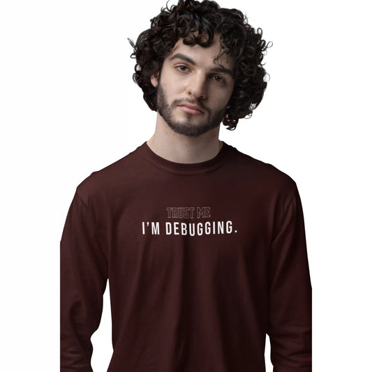 Man wearing a brown long-sleeve shirt with 'Trust Me I'm Debugging' text on a white background
