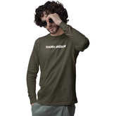 Man wearing a green long-sleeve shirt with 'THINK AGAIN' text, holding sunglasses to his face on a white background.