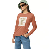Woman wearing a brown long-sleeve shirt with a floral design, blue jeans, and a green bucket hat on a white background.