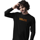 Man wearing a black long-sleeve shirt with 'ENDLESS' text on a white background