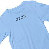 Light blue t-shirt with 'GROW' text on a white background