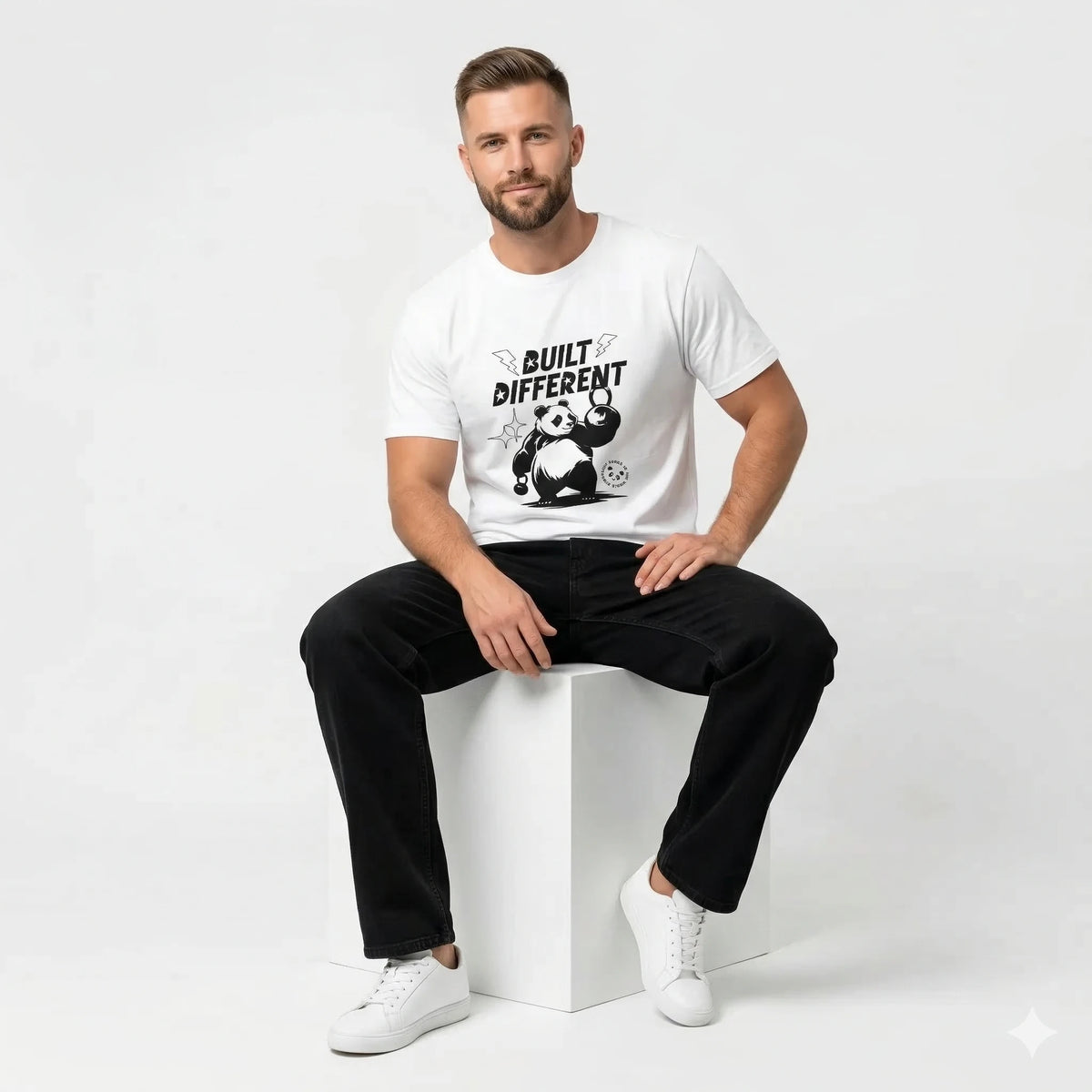White t-shirt with panda graphic and 'Built Different' text on a beige background