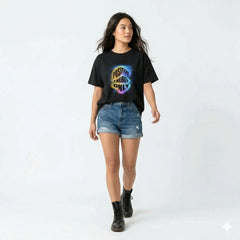 Black t-shirt with 'Positive Energy Only' design on a hanger against a white wall with plants.