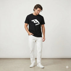 Black t-shirt with a white logo on a hanger against a white wall with plants.