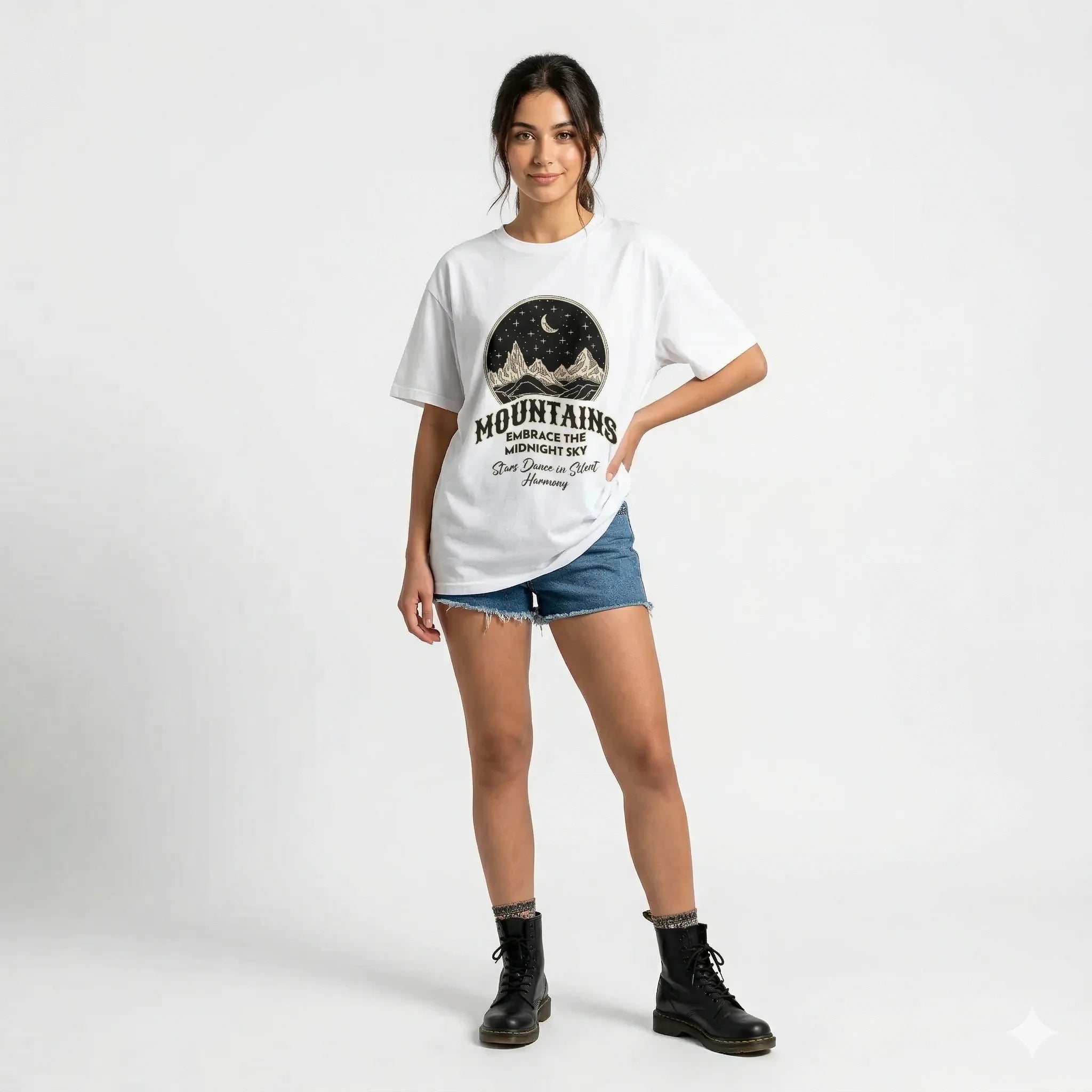 White t-shirt with mountain graphic and text on a gray background