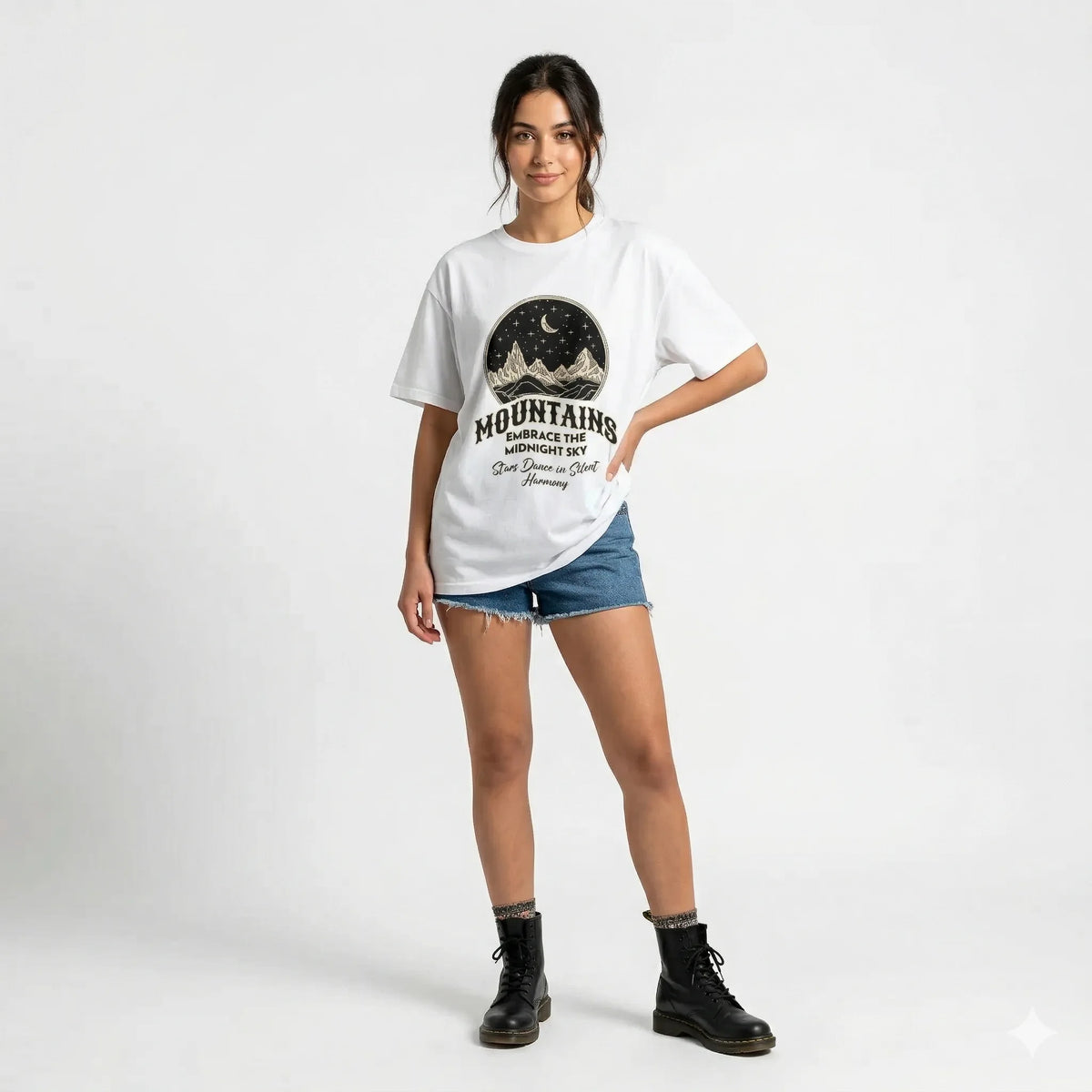 White t-shirt with mountain graphic and text on a gray background