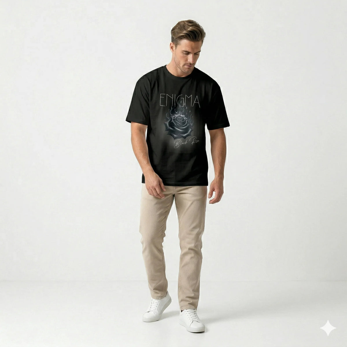 Man wearing a black t-shirt with 'Enigma' design on a white background