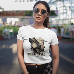 Woman wearing a white t-shirt with a graphic design at an amusement park.