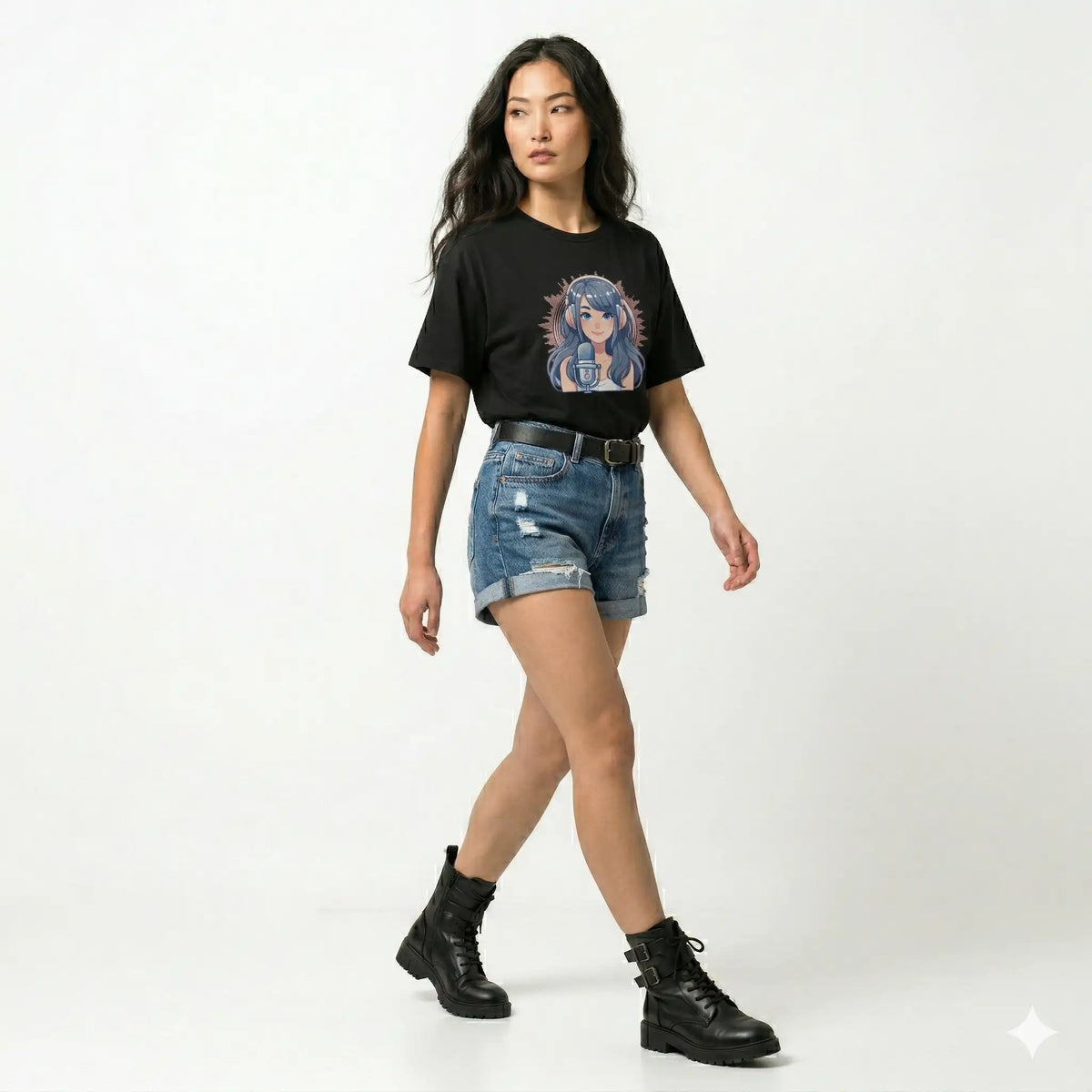 Woman wearing a black t-shirt with a graphic design, blue denim shorts, and black boots on a white background