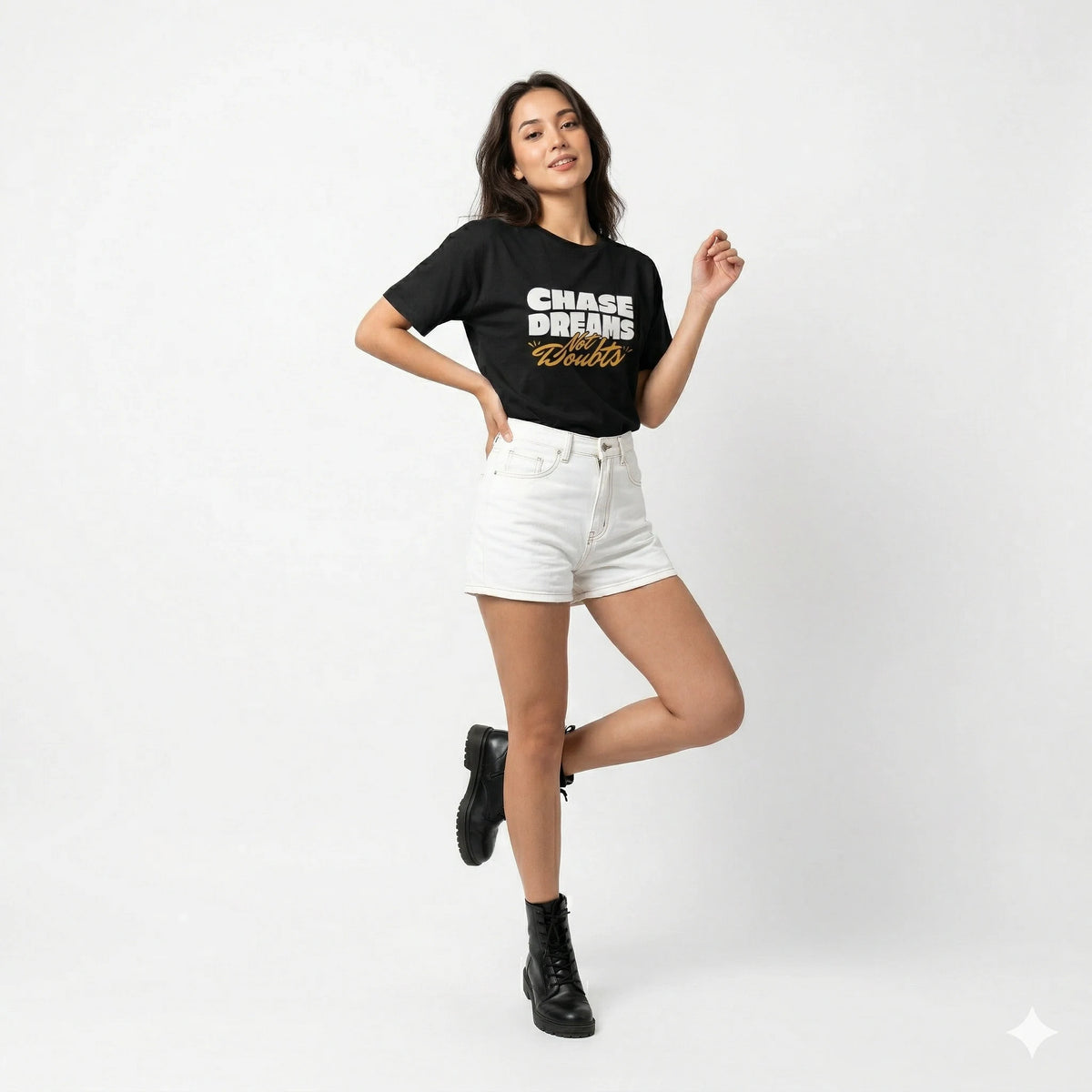 Woman wearing a black t-shirt with text and white shorts on a white background