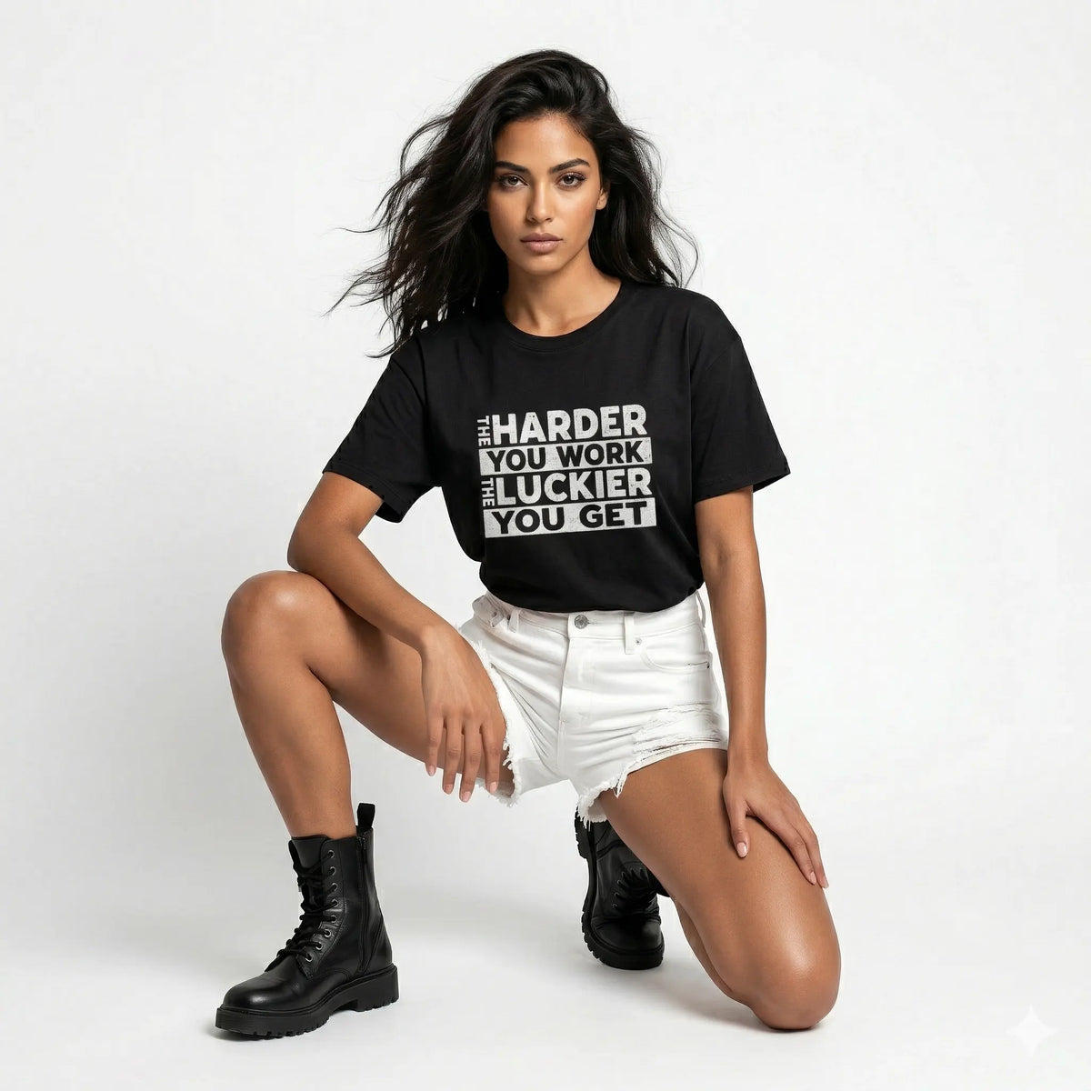 Woman wearing a black t-shirt with motivational text, posing on a white background