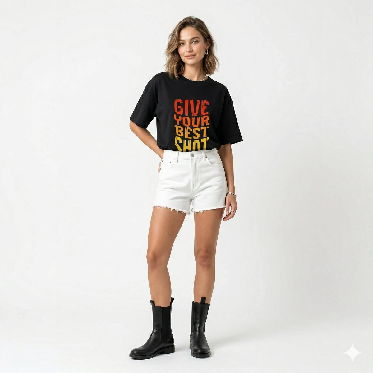 Person wearing a black t-shirt with 'Give Your Best Shot' text, white shorts, and black boots on a white background