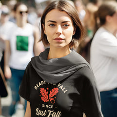 Woman wearing a black t-shirt with a graphic design in an outdoor setting