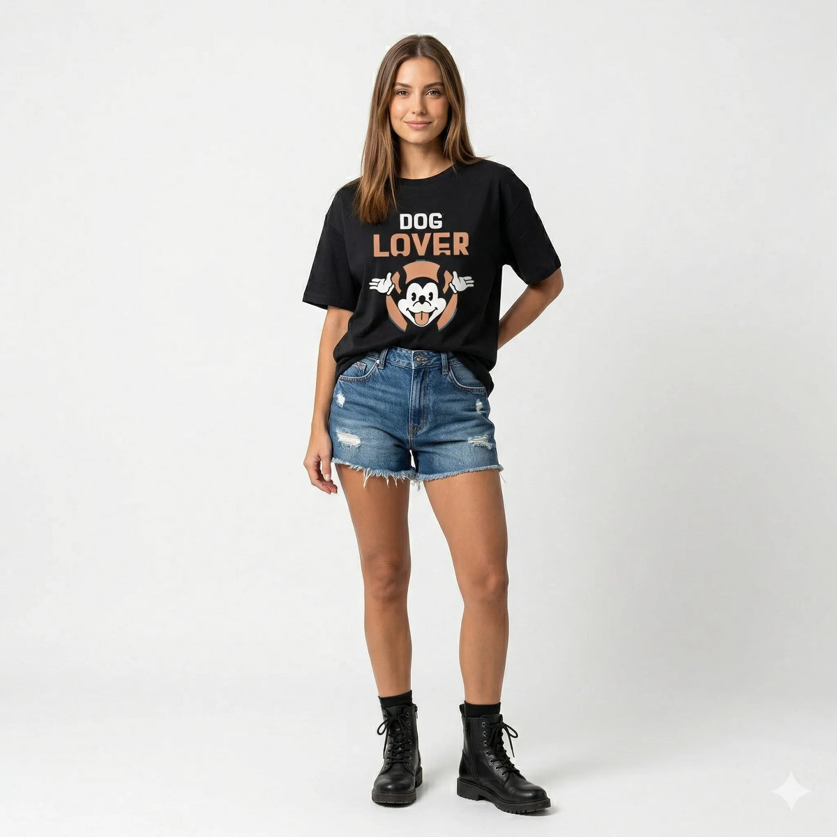 Woman wearing a black 'DOG LOVER' t-shirt with denim shorts on a white background