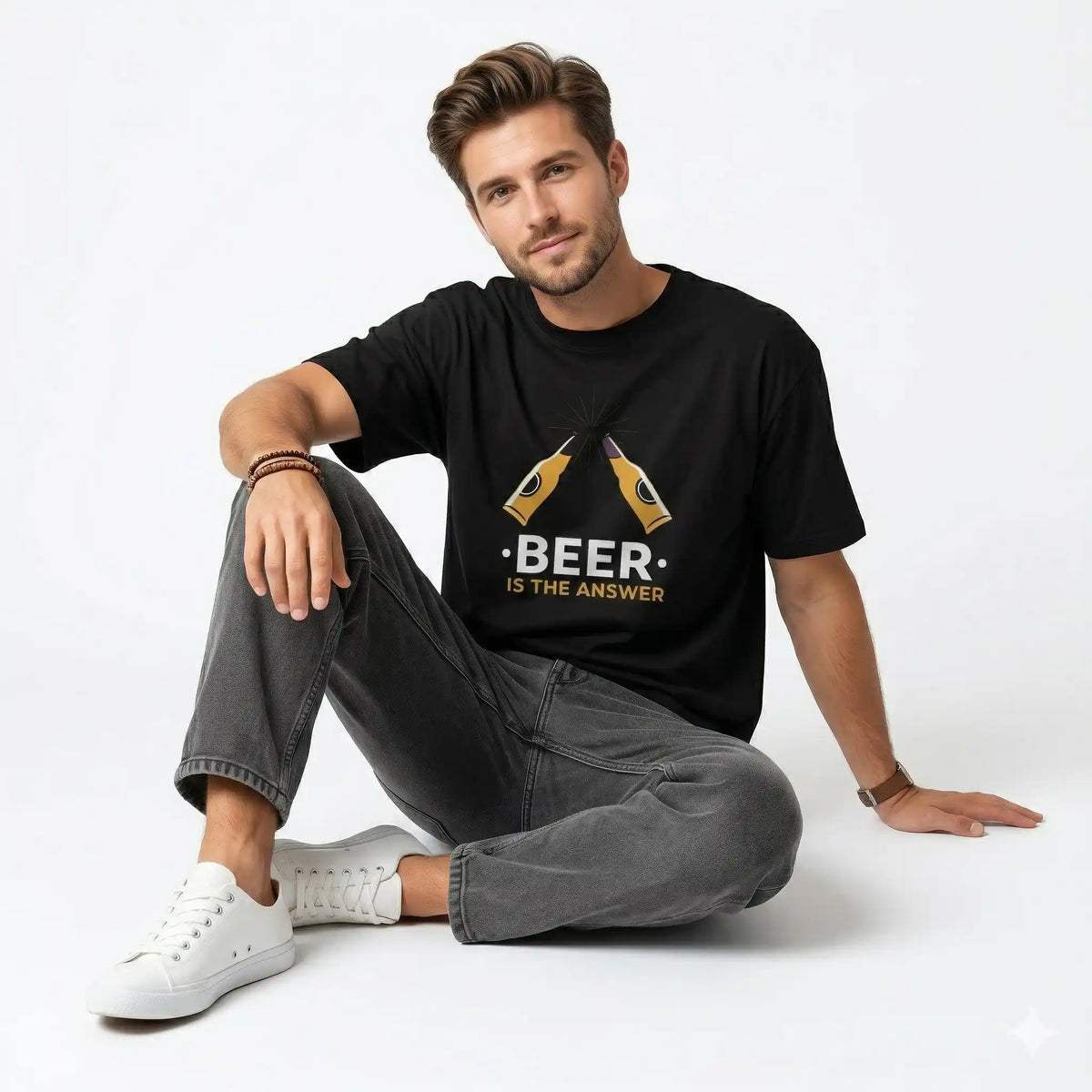Man wearing a black t-shirt with 'BEER is the answer' text leaning against a wall.