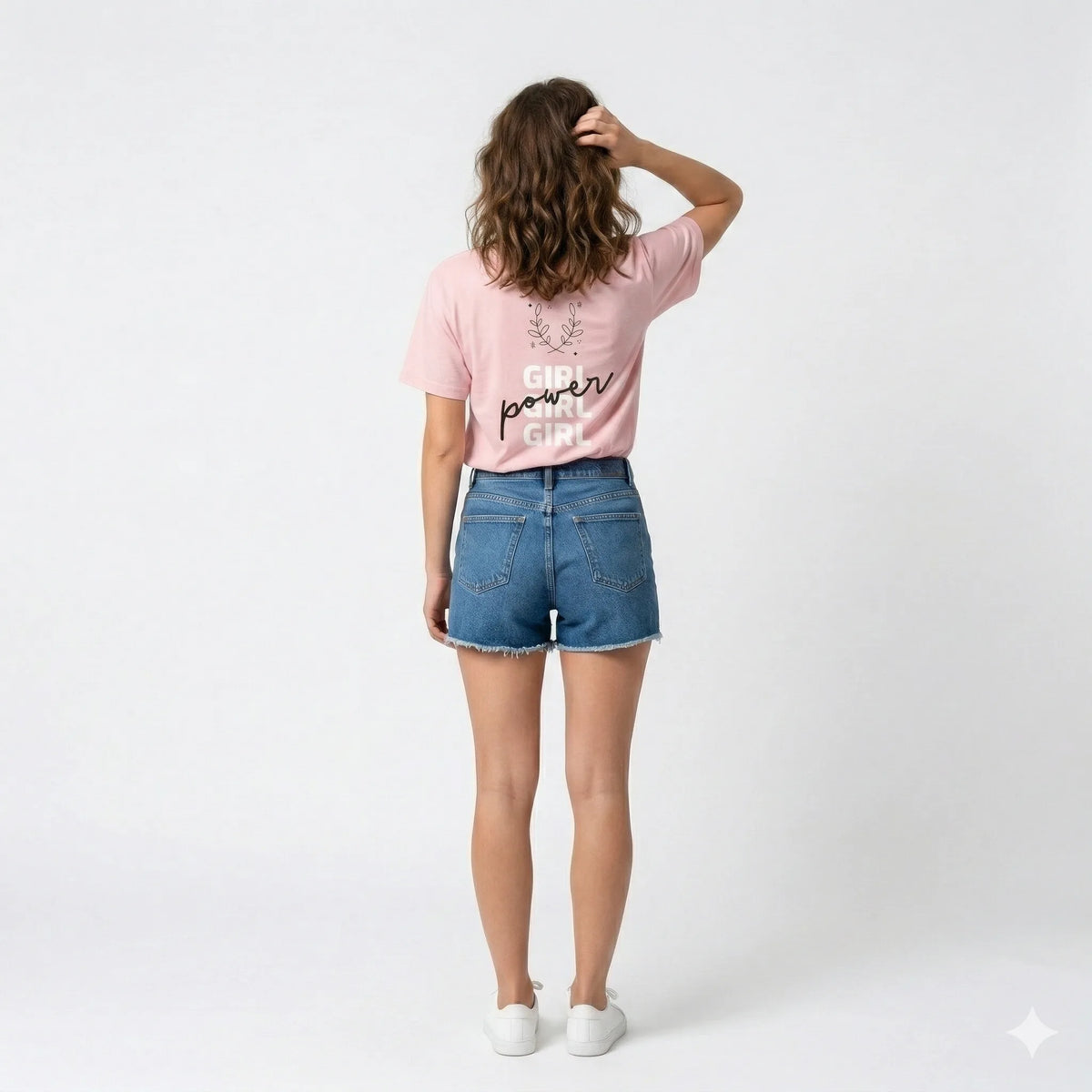 Person wearing a pink t-shirt with 'Girl Power Girl Girl' text and a purple bag.