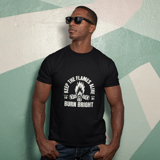 Man wearing a black t-shirt with a motivational quote against a geometric-patterned wall.