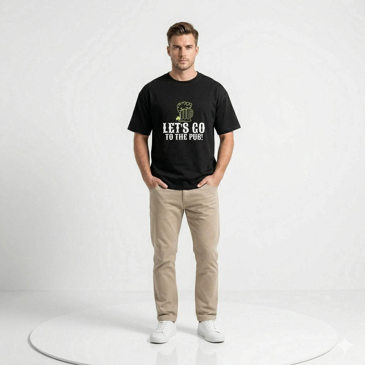 Man wearing a black t-shirt with 'Let's Go to the Pub!' text and graphic outdoors.
