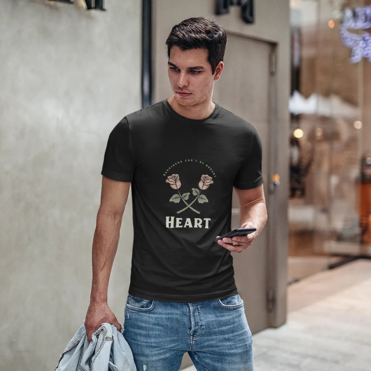 Man wearing a black t-shirt with a graphic design, standing in an urban setting.