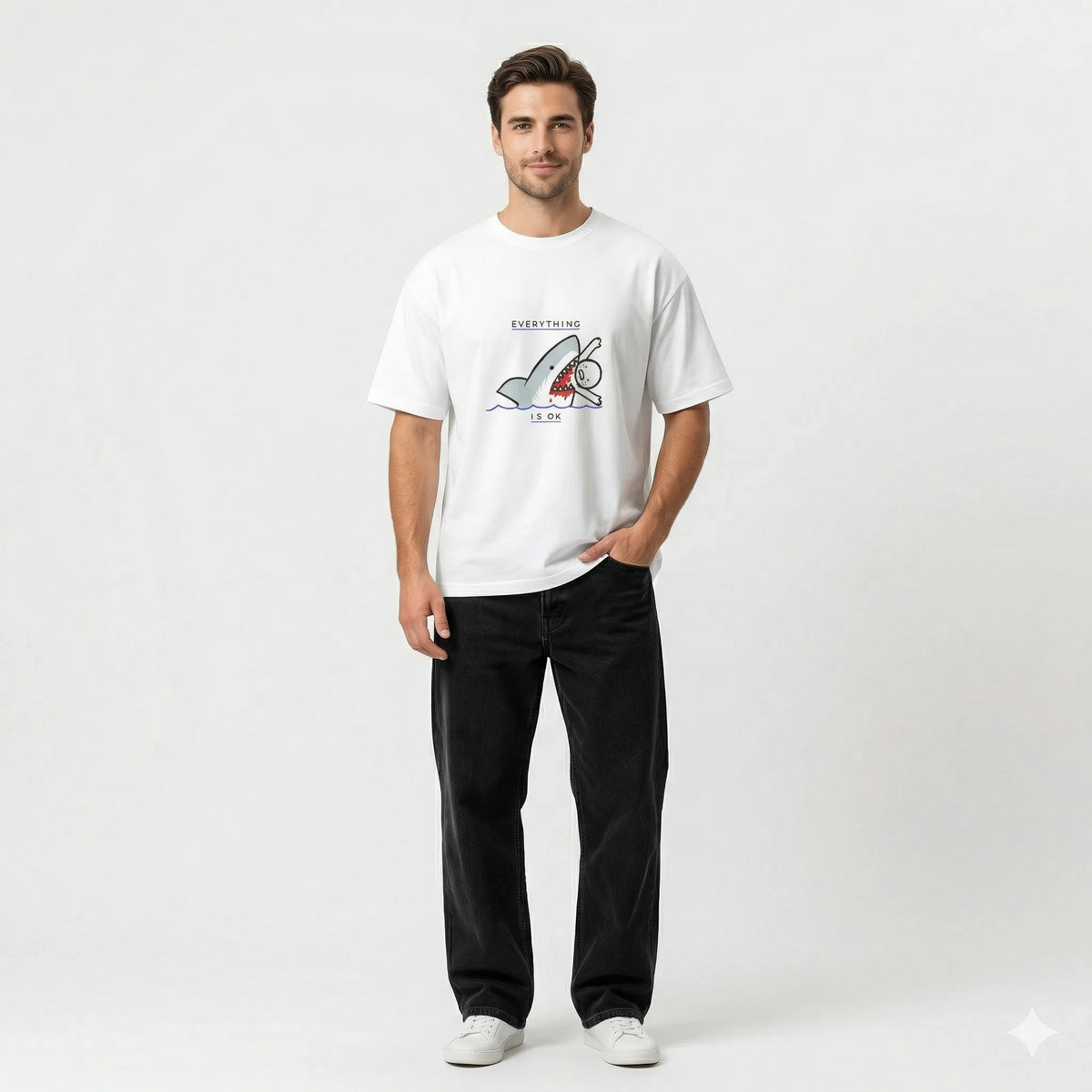 Man wearing a white t-shirt with a graphic design in an indoor setting